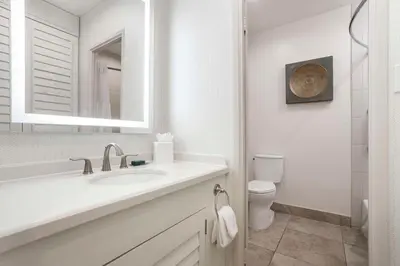 a white bathroom with a sink and a toilet at DoubleTree by Hilton San Diego Bayside in San Diego