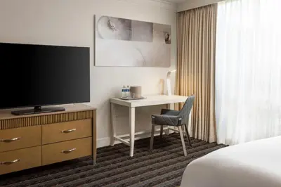 a hotel room with a bed and a desk with a television at DoubleTree by Hilton San Diego Bayside in San Diego