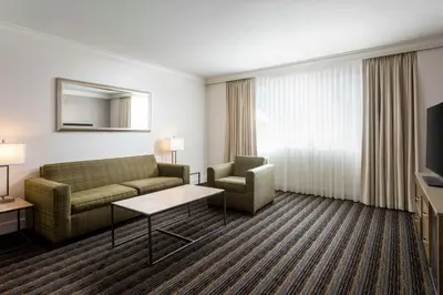 a hotel room with a couch and a chair and a television at DoubleTree by Hilton San Diego Bayside in San Diego