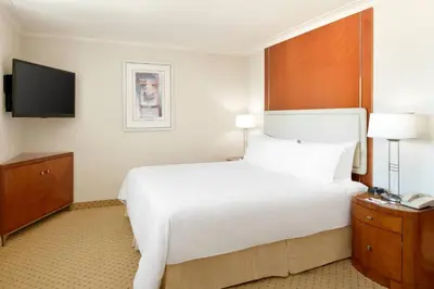 a hotel room with a large bed and a television at San Diego Marriott Gaslamp Quarter in San Diego
