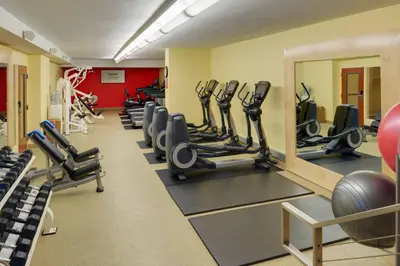 a gym with rows of treadmills and exercise equipment at San Diego Marriott Gaslamp Quarter in San Diego