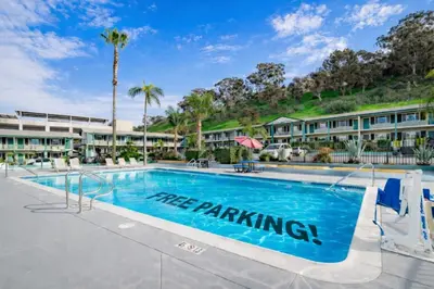 a pool at a resort with a tree parking sign at The Atwood Hotel San Diego - SeaWorld/Zoo in San Diego