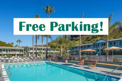 a pool at a resort with a sign that reads free parking at The Atwood Hotel San Diego - SeaWorld/Zoo in San Diego