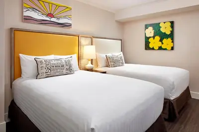 two beds in a hotel room with two beds at The Bristol Hotel San Diego in San Diego