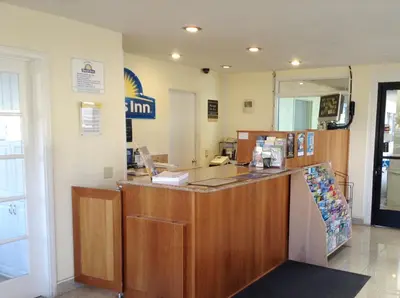a restaurant with a counter in a room at Days Inn by Wyndham Oceanside in Oceanside