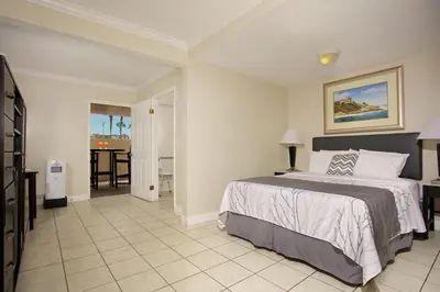 a bedroom with a bed and a living room at Ocean Beach Hotel in San Diego
