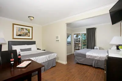 a hotel room with two beds and a table at Ocean Beach Hotel in San Diego