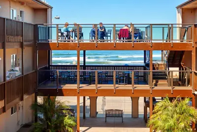 a view of the beach from a balcony at a resort at Ocean Beach Hotel in San Diego