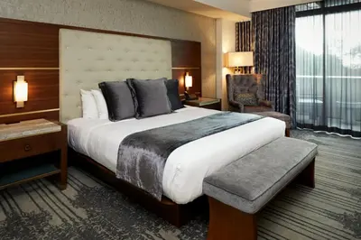a hotel room with a large bed and a chair at Legacy Resort Hotel & Spa in San Diego