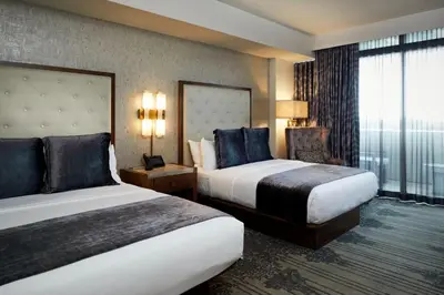 a hotel room with two beds and a window at Legacy Resort Hotel & Spa in San Diego