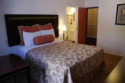 a hotel room with a large bed and a table at Harborview Inn & Suites-Convention Center-Airport-Gaslamp-Seaworld-Zoo-Balboa Park in San Diego