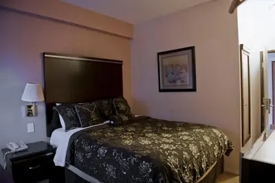 a hotel room with a bed and a telephone at Harborview Inn & Suites-Convention Center-Airport-Gaslamp-Seaworld-Zoo-Balboa Park in San Diego
