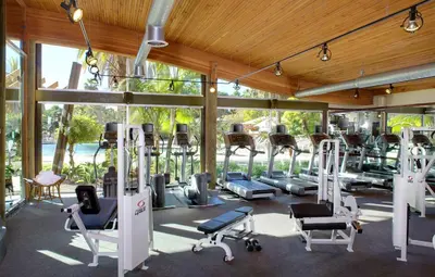 a gym with a lot of treadmills and machines at Paradise Point Resort & Spa in San Diego