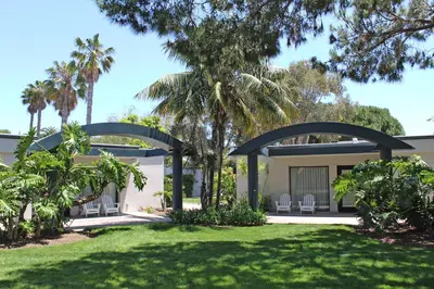 a view of a house with chairs and palm trees at Paradise Point Resort & Spa in San Diego