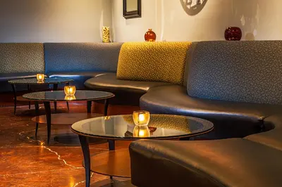 a room with couches and tables with candles on them at Handlery Hotel San Diego in San Diego