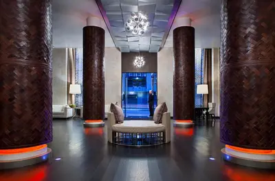 a lobby with columns and a chair and a chandelier at Andaz San Diego, By Hyatt in San Diego