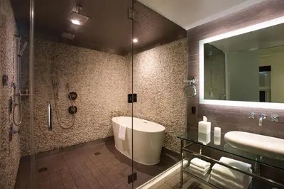 a bathroom with a shower and a tub and a sink at Andaz San Diego, By Hyatt in San Diego