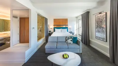 a hotel room with a bed and a couch and a table at Andaz San Diego, By Hyatt in San Diego
