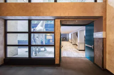 a hallway with a glass door with a group of statues at Andaz San Diego, By Hyatt in San Diego