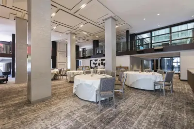 a dining room with white tables and chairs at Andaz San Diego, By Hyatt in San Diego