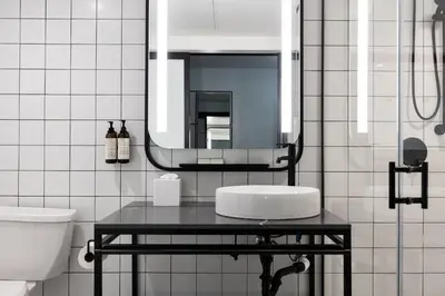 a bathroom with a sink and a mirror at The Guild Hotel, San Diego Downtown, a Tribute Portfolio Hotel in San Diego