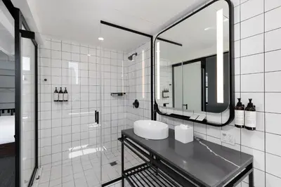 a bathroom with a sink and a mirror at The Guild Hotel, San Diego Downtown, a Tribute Portfolio Hotel in San Diego