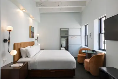 a hotel room with a bed and a desk at The Guild Hotel, San Diego Downtown, a Tribute Portfolio Hotel in San Diego