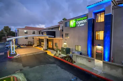 a hotel with a parking lot in front of a building at Holiday Inn Express Hotel & Suites Carlsbad Beach by IHG in Carlsbad