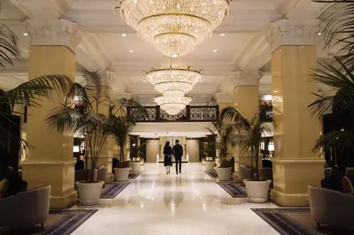 a couple walks through the lobby of a hotel at The US Grant, a Luxury Collection Hotel, San Diego in San Diego