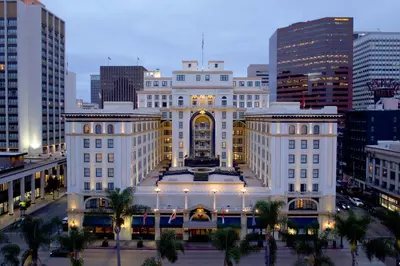 a large white building in the middle of a city at The US Grant, a Luxury Collection Hotel, San Diego in San Diego