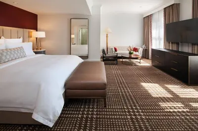 a hotel room with a large bed and a television at The US Grant, a Luxury Collection Hotel, San Diego in San Diego