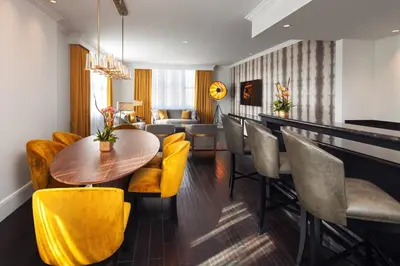 a dining room with a table and yellow chairs at The US Grant, a Luxury Collection Hotel, San Diego in San Diego