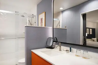 a bathroom with a sink and a mirror at Tiller House, Laguna Hills, a Tribute Portfolio Hotel in Laguna Hills