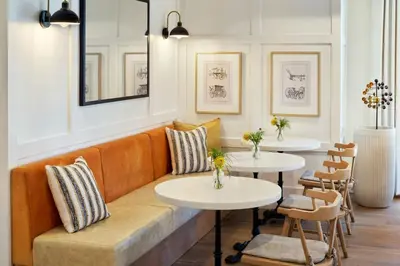 a restaurant with two tables and a couch at Tiller House, Laguna Hills, a Tribute Portfolio Hotel in Laguna Hills