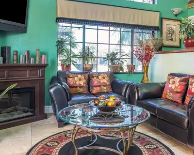 a living room with a couch and a table with a bowl of fruit at Quality Inn Hemet - San Jacinto in Hemet