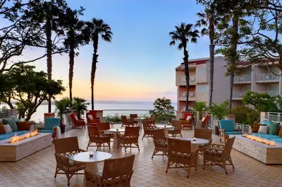 a patio at the beach hotel with tables and chairs at Loews Coronado Bay Resort in San Diego