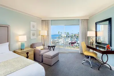 a hotel room with a bed and a desk with a desk at Loews Coronado Bay Resort in San Diego