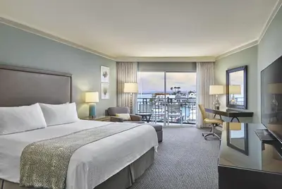 a hotel room with a bed and a balcony at Loews Coronado Bay Resort in San Diego