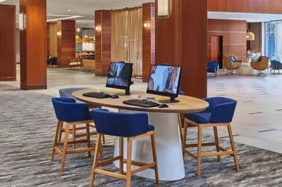 a lobby with a table with two computer monitors on it at The Westin San Diego Gaslamp Quarter in San Diego