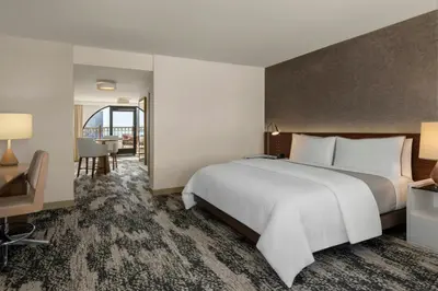 a hotel room with a large bed and a table at The Westin San Diego Gaslamp Quarter in San Diego