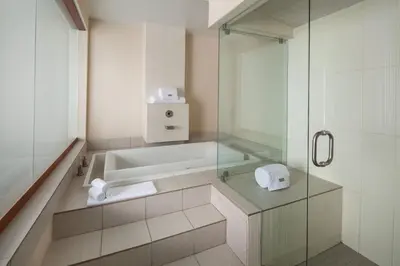 a bathroom with a tub and a glass shower at The Westin San Diego Gaslamp Quarter in San Diego