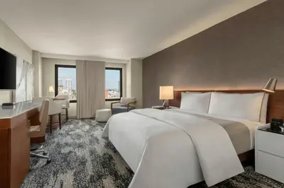 a hotel room with a large bed and a desk at The Westin San Diego Gaslamp Quarter in San Diego