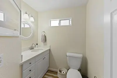 a bathroom with a toilet and a sink and a mirror at Luna Azul, cozy condo only steps to Mission Beach! Free Internet in San Diego