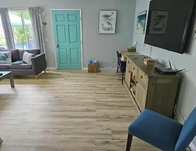 a living room with a television and a blue door at Luna Azul, cozy condo only steps to Mission Beach! Free Internet in San Diego