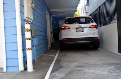 a white car is parked in a garage at Luna Azul, cozy condo only steps to Mission Beach! Free Internet in San Diego