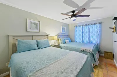 a bedroom with two beds and a ceiling fan at Luna Azul, cozy condo only steps to Mission Beach! Free Internet in San Diego