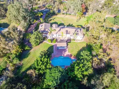 an overhead view of a large house with a swimming pool at Rancho Garden Home in Rancho Santa Fe