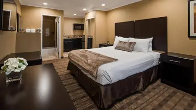 a hotel room with a large bed and a bathroom at Best Western Poway/San Diego Hotel in Poway