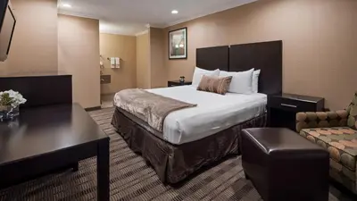 a hotel room with a large bed and a couch at Best Western Poway/San Diego Hotel in Poway