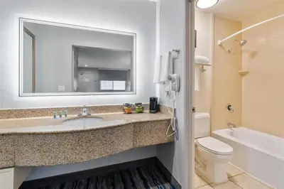 a bathroom with a sink and a toilet and a mirror at Best Western San Diego/Miramar Hotel in Miramar